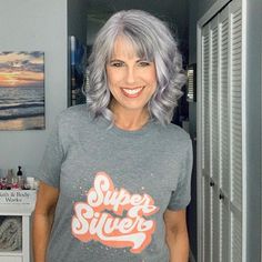 If you feel the libration that comes with natural silver hair, this is the perfect Tee in which to announce it to the world! This comfortable tee has a unisex cut with longer sleeves and body giving you tons of options for styling. We love tucking in the tee, tying it in a knot, or rolling up the sleeves for summer and then keep it loose for just lounging around the house. Sizes S - 3XL. Wash before wearing, they have a fresh print smell. Arrives within 2 weeks for US residents and 4 weeks for I Natural Silver Hair, Grey Hair With Bangs, Grey Hair Looks, Gorgeous Gray Hair, Grey Hair Inspiration, Silver Sisters, Beautiful Gray Hair, Grey Hair Styles For Women, Silver Grey Hair