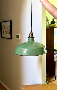 a green light hanging from the side of a wall