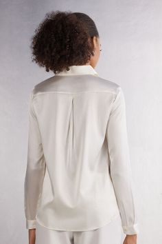 Long sleeve shirt in light stretch silk with collar and buttons up the middle. Back yoke with pleat for a draped, loose fit. Buttoned cuffs and rounded hem. Cream Silk Top For Workwear, Workwear Silk Blouse With Spread Collar, Silk Blouse With Spread Collar For Workwear, Timeless Blouse With Fold Down Collar For Daywear, Elegant Silk Button-up Top, Elegant Spread Collar Tops For Fall, Elegant Blouse With Spread Collar For Fall, Elegant Spread Collar Blouse For Fall, Silk Blouse For Work With Fold Down Collar