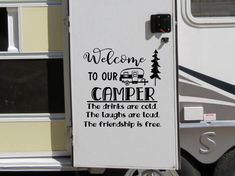 a camper door with the words welcome to our camper and trees on it