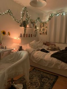 a bed room with a neatly made bed next to a desk and window covered in lights