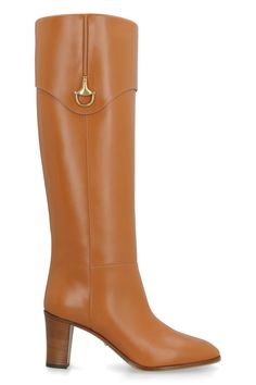 Step out in style and luxury with these exquisite leather boots featuring a half horsebit detail in aged gold-tone metal. The round toeline adds a touch of sophistication, making these boots the perfect addition to any fashion-forward wardrobe. Crafted from 100% leather, these boots are not only stylish but also high-quality, ensuring both comfort and durability with every step. Elevate your look and make a statement with these stunning leather boots. Whether you're pairing them with your favori Leather Knee Boots, Saddle Brown, Gucci Leather, Leather Cap, Brown Leather Boots, Beach Tote Bags, Designer Boots, Lanvin, Favorite Jeans