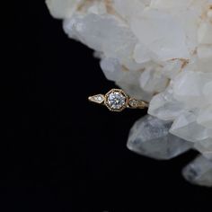 a diamond ring sitting on top of some rocks