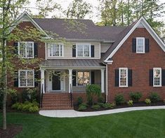 a brick house with black shutters and white trim