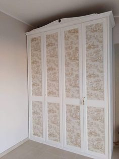 an empty room with white cabinets and tile flooring on the walls, in front of a beige wall