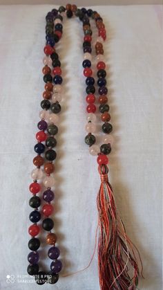 108 Beads/ Natural jade multi Colour Gemstone Japa Mala Prayer Beads multi colour Round Beads Japa Mala Guru beadr Beads semi-precious Gemstone Round Beads // Long Tassel Necklace// Meditation japa mala // Guru bead// Necklace Yoga Beads multi Color // 8 mm Bids size - 8mm approx It is known as the 'love stone' as the message it emits is the strong vibration of unconditional love, joy, warmth and healing. As quartz crystals are profound amplifiers of energy, it may help to kindle happiness, love Colorful Natural Stone Beaded Necklaces With Round Beads, Colorful Beaded Necklaces With Natural Stones, Hand-strung Multicolor Beads For Gifts, Colorful Gemstone Beaded Necklaces With Round Beads, Colorful Gemstone Beaded Necklaces, Adjustable Multicolor Natural Stone Beads, Adjustable Multicolor Gemstone Beaded Necklaces, Multicolor Natural Stone Beads As Gift, Multicolor Natural Stone Beads For Gifts