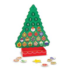 a wooden christmas tree with buttons and numbers on it's side, in front of a white background