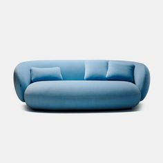 a blue couch sitting on top of a white floor