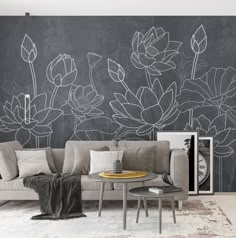 a living room with a couch, coffee table and chalkboard on the wall behind it