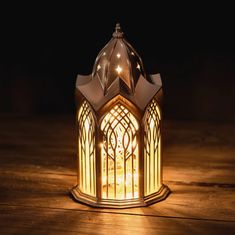 a lit up lantern sitting on top of a wooden table