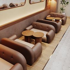 a row of couches sitting next to each other in front of a wall with mirrors on it