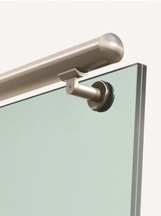 a close up view of the handle on a glass door with a metal bar attached to it