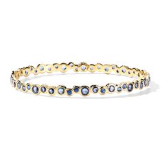 It’s all about jewel placement on this Stardust bracelet. The settings make the lustrous blue sapphires appear scattered at random, however each gem is hand-selected and placed with precision. The gleaming bangle is cast from 18K gold — a beautiful complement to the inky color of the stones. • 18K Gold • Gemstones: Blue Sapphire