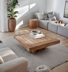 a living room filled with furniture and a wooden coffee table