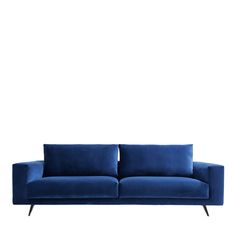 a blue couch sitting on top of a white floor