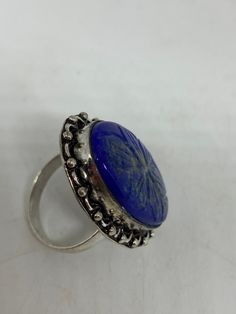 Large genuine blue Lapis Lazuli Vintage ring Flower hand carved Low content silver not sterling. Size 9 Can be re sized. My jeweler charges $10-$20 All rings are shipped in a nice gift box. Check out our over a THOUSAND great reviews Engraving is $4 per letter and is not always perfect depending on the piece. It can take a few days if the jeweler is busy. This is payable to Paypal Judithsltd@gmail.com Blue Gemstone Flower Ring Gift, Gift Blue Gemstone Flower Ring, Engraved Round Sapphire Jewelry, Artisan Blue Engraved Jewelry, Artisan Engraved Blue Jewelry, Blue Flower Ring For Gift, Unique Blue Flower Ring For Gift, Adjustable Carved Jewelry For Anniversary, Unique Blue Engraved Jewelry