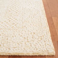 a white rug on the floor with wooden floors