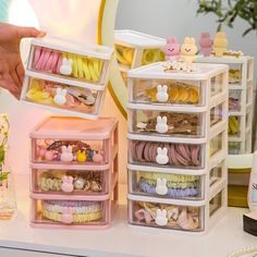 plastic storage containers filled with various items on a table next to flowers and other decorations