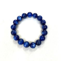 Kyanite Gemstone Japanese Juzu Bracelet Characteristics of the product Material : Kyanite, Silk elastic cordWrist size : 17～18cm/6.7～7.1in (Stretch) ※The number of beads may be different from the picture. (depends on the product) We adjust the size to your wrist for a fee.Main beads : about 12mm Handmade in Kyoto, JAPAN About kyanite Kyanite is an excellent stone for meditation, aligning all chakras and soothing your body instantly. It provides balance of yin-yang energy and dispels any blockage, moving energy gently through the physical body. Blue Kyanite opens the throat chakra, encouraging communication and self-expression. It helps you face fears and speak the truth. It is very useful for public speakers and performers as it strengthens the voice and heals the throat and the larynx. It Moving Energy, Kyanite Bracelet, Yang Energy, Kumihimo Bracelets, Traditional Ceramics, Amber Bracelet, Blue Kyanite, Kyoto Japan, Throat Chakra