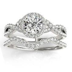 a white gold ring with diamonds on top and an engagement band in the middle,