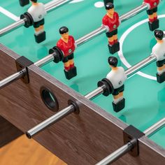 foosball table with many small plastic figurines on it's sides