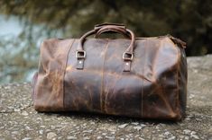 This duffle bag is made with some of the finest genuine leather I've ever seen. It's a great bag to use when packing your clothes and things in, while going on vacation. It's durable and looks fantastic! #leather #leatherbag #bag Travel Bag With Canvas And Leather Backing, Travel Canvas Bag With Leather Backing, Travel Bags With Leather Lining And Canvas Material, Canvas Travel Bag With Leather Lining, Travel Canvas Bag With Leather Lining, Brown Canvas Duffle Bag For On-the-go, Leather Tote Travel Bag With Waxed Finish, Leather Tote Duffle Bag With Waxed Finish, Weekend Satchel Bag With Leather Backing