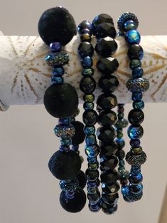 Unique bracelet stack, no one else will have one like this, cute flocked black beads, mixed with purplish beads, black crystal beads. These are a stretchy set, 4 bracelets. Approximately 7 inches. Will look great worn together or separately. Get ready for ooos and ahhs when you wear this stack. Cheap Multicolor Beaded Bracelets With Black Beads, Bohemian Black Crystal Bracelet With 8mm Beads, Black Bohemian Crystal Bracelet With Round Beads, Bohemian Black Crystal Bracelet With Round Beads, Bohemian Black Stretch Bracelet With 8mm Beads, Black Stretch Bracelet With Faceted Round Beads, Handmade Black Beaded Bracelets For Parties, Black Bohemian Beaded Bracelets With Faceted Beads, Handmade Black Beaded Bracelet For Parties