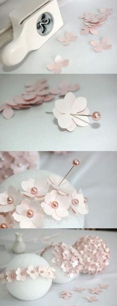 some pink paper flowers on top of a white table