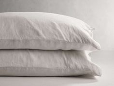 two white pillows stacked on top of each other