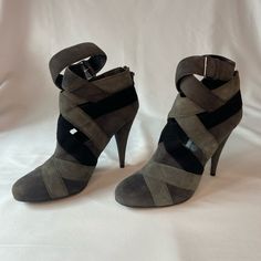 These Charcoal Grey, Grey, And Black Miu Miu Suede Goatskin Booties Have Been Worn A Couple Times But Are Still In Very Good Condition. They Have Cutout Details On The Ankles, And The Heel Is 4.5 Inches. The Ankle Straps Are Also Adjustable. One Of The Leather Details On The Zipper Is Sadly Missing, But The Zippers Work Fine On Both Boots. Note: No Returns, And All Communications And Purchases Will Be Through Poshmark. Thank You! Gray High Heels Medium Width, Gray Ankle Strap Heels For Evening, Chic Gray Ankle Strap Heels, Gray Leather Heels With Round Toe, Gray Round Toe Heels Medium Width, Gray Round Toe Medium Width Heels, Gray Closed Toe Heels For Fall, Chic Gray Closed Toe Heels, Gray Medium Width Round Toe Heels