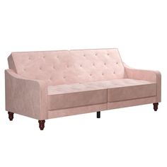 a pink couch sitting on top of a white floor