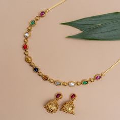 Description: Experience the fusion of tradition and contemporary elegance with our Navratna Necklace. Each of the nine vibrant Navratna gemstones is studded in a string to make your style classic and minimal. This piece pays homage to India's rich cultural heritage and spiritual significance, symbolizing the auspiciousness of each Navratna gem. Details & Specifications: Materials used: Brass Alloy with Antique Gold Platting Weight -Necklace-18.50 gm, Earrings-15.85 gm Length - Necklace-9.5 cm, E Simple Navaratna Necklace, Spiritual Kundan Necklace With Gemstones For Celebration, Spiritual Stone Necklace For Festive Occasions, Festive Spiritual Stone Necklace, Round Gemstone Temple Necklace For Festive Occasions, Spiritual Kundan Necklace With Gemstone For Festive Season, Festive Necklaces With Stone Setting, Spiritual Gemstone Necklaces For Celebration, Elegant Multi-stone Necklace For Diwali