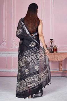 Flaunt your elegant style every day in this elegant black floral print linen saree with silver zari border. It comes with a matching blouse piece. Disclaimer: The shown stitched blouse on the model is for display purpose only. The saree comes with a matching blouse piece and finished with fall and piko. Black Block Print Saree With Traditional Drape, Black Saree With Block Print And Traditional Drape, Silver Chanderi Saree, Black Block Print Dupatta, Tussar Silk Sarees, Indian Clothing Store, Latest Designer Sarees, Linen Saree, Fashion Journals