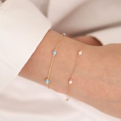 With this 14k Gold White, Light Blue, and Dark Blue Opal Round Bracelets, you may explore the fascinating world of opals. Choose from three opal colors: white opal's purity, light blue opal's tranquillity, or dark blue opal's depth. Each opal reflects the spirit of October's birthstone, making it a lovely gift for Libras or anybody born in this month. Opals are associated with Venus, the goddess of love and beauty, making this bracelet a symbol of appeal and elegance. Whether you choose the soot Blue Birthstone Bracelets In Fine Jewelry Style, Blue Birthstone Bracelets Fine Jewelry, Blue Dainty Birthstone Bracelets, Dainty Blue Gemstone Bracelets, Dainty Blue Gemstone Bracelet, Blue Bracelet Jewelry For Birthday, Dainty Blue Jewelry For Birthday Gift, Blue Gold Bracelet With 17 Jewels For Gift, Fine Jewelry Blue Gold Bracelet For Gift