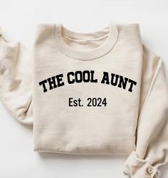 Custom The Cool Aunt Est. Sweatshirt, The Cool Aunt Shirt, Birthday Gift for Aunt, Christmas Gift for Aunt, New Aunt T Shirt, Auntie Hoodie How To Order? 1-) Please, check and review all photos, 2-) Choose your Size and Color, 3-) Click add to cart. You can go back to add more product 4-) Click "Proceed to check out" 5-) When you check out, you can add a note to seller for any request Unisex Adult T-Shirt * Unisex t shirt fits like a well-loved favorite, featuring a crew neck, short sleeves and Cricut Gifts For Aunt, Cotton Sweatshirt For Birthday In Winter, Cotton Sweatshirt For Winter Birthday, White Tops For Birthday And Winter, White Top For Birthday In Winter, Casual Cotton Hoodie For Birthday, Cotton Top For Birthday In Winter, Cotton Tops For Birthday In Winter, Casual Winter Birthday Tops