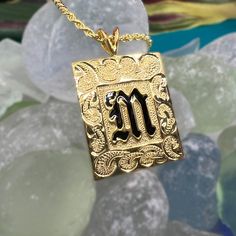 Feel the aloha with this personalized pendant! Our custom-engraved Hawaiian Scroll Heirloom Initial Pendant is available in 14k gold plated sterling silver or sterling silver. Add a special message to the back for just $15 and guarantee it's one-of-a-kind! Each pendant comes with a 20" gold-filled rope chain, making it perfect for both men and women. Mahalo! 14K Gold Plating over .925 Sterling Silver or Sterling Silver Choose Initial in Black Enamel or Raised Lettering Pendant is approx. 1" Tall Customized Nameplate Jewelry For Personalized Gift, Gold Spiritual Initial Pendant Jewelry, Spiritual Gold Initial Pendant Jewelry, Spiritual Gold Jewelry With Initial Pendant, Custom Gold Jewelry For Personalized Gift, Symbolic Gold Initial Pendant Jewelry, Sterling Silver Nameplate Jewelry With Initials, Custom Gold Nameplate Jewelry, Symbolic Engraved Initial Pendant Jewelry