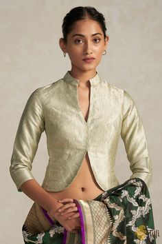 "Fit for royalty. This jacket-style blouse, made with the finest handwoven Banarasi brocade fabric is charming, versatile and regal. Leave everyone enraptured.\n\u00a0\n\n\n Color - A beautiful\u00a0shade of\u00a0Green\n\n Fabric - Pure Katan Silk\nNote - The blouse is made in standardized sizes as specified below\nPlease allow 10-12 business days for despatch.\u00a0\n\n" Luxury Katan Silk Blouse With Cutdana, Luxury Brocade Blouse With Cutdana, Luxury Katan Silk Blouse Piece With Cutdana, Luxury Unstitched Brocade Blouse Piece, Luxury Banarasi Silk Bollywood Blouse Piece, Luxury Brocade Tops With Zari Work, Luxury Ceremonial Katan Silk Blouse Piece, Luxury Banarasi Silk Blouse Piece In Pista Green, Unstitched Luxury Brocade Blouse Piece