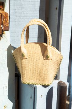 Kaki and natural raffia bag. The Gigi is your best ally for all occasions ! As a beach bag, a city basket or an evening purse to dress up your outfit, the Gigi is fit for all occasions and for all women. This trendy raffia bag is handmade in the purest tradition of raffia weaving. Carry by hand or at the shoulder, it is therefore the perfect fashion accessory ! But that's not all ! The Gigi aims to embellish your daily life every season with positivity and kindness throughout lithotherapy. That' Elegant Natural Beach Bag For Beach Season, Elegant Handwoven Jute Straw Bag, Chic Palm Leaf Straw Bag With Braided Handles, Natural Straw Bag Fair Trade, Natural Straw Fair Trade Bag, Natural Color Fair Trade Straw Bag For Beach, Fair Trade Straw Beach Bag, Fair Trade Straw Bag For Beach, Fair Trade Jute Straw Bag For Beach