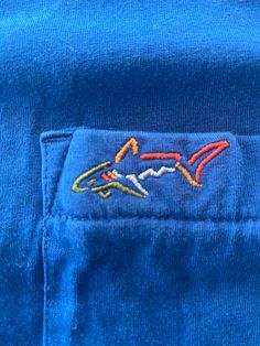 Greg Norman Collection Golf Shark T-Shirt ** Royal Blue **  Fits like a Medium.  See pics for measurements  Australian Golfer  Cool Colorful Logo Fine condition  Quick shipping. We ship same or next day with USPS mail  We are a small family business and we appreciate your purchase, Godspeed !  DS Pre-shrunk Blue Crew T-shirt, Blue Cotton Crew T-shirt, Blue Cotton T-shirt With Embroidered Logo, Blue Cotton Crew Neck T-shirt, Casual Blue Tops With Embroidered Logo, Blue Casual Top With Embroidered Logo, Casual Blue Top With Embroidered Logo, Blue Pre-shrunk Crew T-shirt, Blue Crew Neck Top With Graphic Print