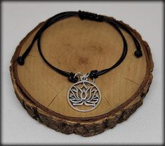 Black bracelet with silver lotus flower pendant. The size of the bracelet can be adjusted using the sliding knot clasp. (This is costume jewelry) Adjustable Black Jewelry With Flower Charm, Lotus Flower Pendant, Black Bracelet, Black Bracelets, Sliding Knot, Body Jewellery, Flower Pendant, Lotus Flower, Arm Band