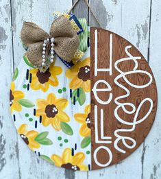 a door hanger decorated with sunflowers and the words happy easter