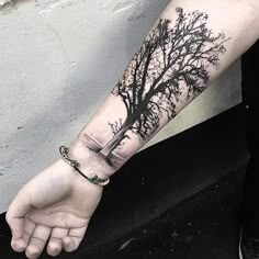 a person with a tree tattoo on their arm