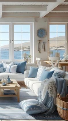 a living room filled with lots of furniture next to a window covered in blue and white pillows