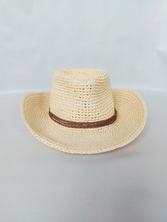 Stylis Cowboy Raffia Fedora Hat  Handmade with care, this hat is made from 100% natural fibers The hat features a beautiful braided lace decoration, adding a touch of elegance to any outfit.  It is also lightweight and breathable, ensuring comfort even on hot summer days.  The wide brim provides excellent sun protection, shielding your face and neck from harmful UV rays. The reguilin tied into the brim helps the hat maintain its shape, ensuring it looks stylish and put-together at all times.  Th Cream Sun Hat With Curved Brim For Rodeo, Cream Short Brim Sun Hat For Rodeo, Natural Brimmed Hat For Ranch, Natural Handwoven Toquilla Straw Hat Bands, Handwoven Natural Toquilla Straw Hat Bands, Natural Toquilla Straw Boater Hat For Rodeo, Flat Brim Natural Hat For Ranch, Natural Brimmed Hat For Rodeo, Braided Flat Brim Panama Hat In Natural Color