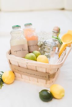 a wicker basket filled with lemons, limes and other condiments