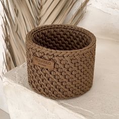 a brown basket sitting on top of a white counter