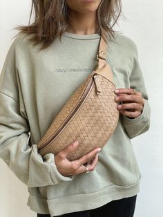 "Check out our other products from our shop below:  https://www.etsy.com/shop/MANDRNdesign Each Woven Atlas Leather Fanny Pack is handmade by highly skilled artisans specializing in the creation of hand-woven and braided leather accessories. Using double the amount of leather of our regular Remy packs, the woven nature of these bags means no two are the same and each pack is as unique as the MANDRN muse who wears it.    PRODUCT FEATURES: - 100% genuine leather in a nude/beige tone - Premium cowhide leather  - Handmade and hand-woven with love by our artisan friends in Bali - Inner pocket with a cotton-drill lining - Hidden top-flap pocket for small items like SIM cards, earrings, rings or emergency Advil - Two inner elastics to hold your lipsticks, essential oil rollers and similar essenti Mandrn Bag, Over The Shoulder Bags, Waist Pouch, Bag Belt, Leather Fanny Pack, Bum Bag, Sand Beige, Leather Pattern, Hip Bag