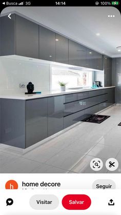 a kitchen with grey cabinets and white counter tops, along with an appliance that reads home decor