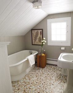 a bathroom with a sink, bathtub and window in the corner on the wall