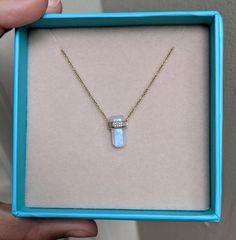 This moonstone has mini diamonds wrapped around it as if they are giving it a little hug! The moonstone has beautiful flashes of blues and purples. Fun, unique, and modern, this necklace won't disappoint! Layer it up with our other dainty chokers and chains for a fun and stylish look. Adjustable chain from 16 to 18 inches. Moonstone (3.270ct) Diamonds (0.05ct) 14k rose gold Pendant: 14x9mm Luxury Moonstone Necklace With Gemstones, Elegant Moonstone Necklaces For Healing, Elegant Moonstone Healing Necklaces, Moonstone Necklaces With Gemstone Accents, Round Moonstone Necklace With Gemstone Accents, Moonstone Pendant Necklace With Stones, How To Clean Silver, Dainty Choker, Professional Jewelry